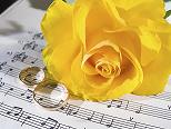wedding rings and a yellow rose resting on sheet music wedding rings and a yellow rose resting on sheet music